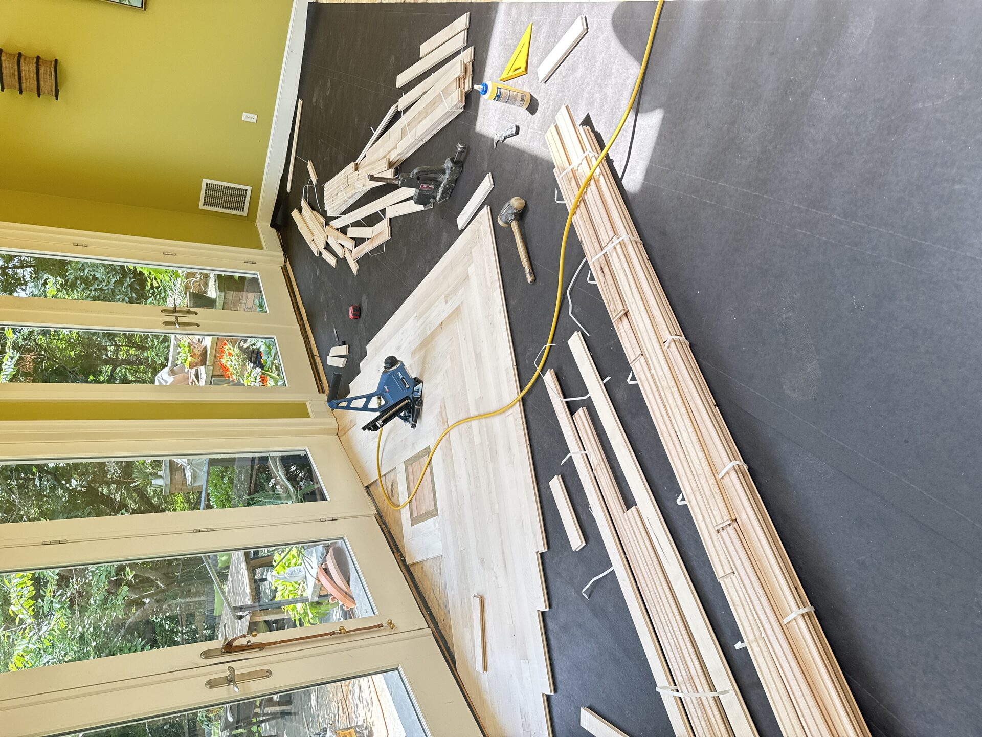 Heritage Hardwood Floors craftsmanship — installer hand-fitting a board