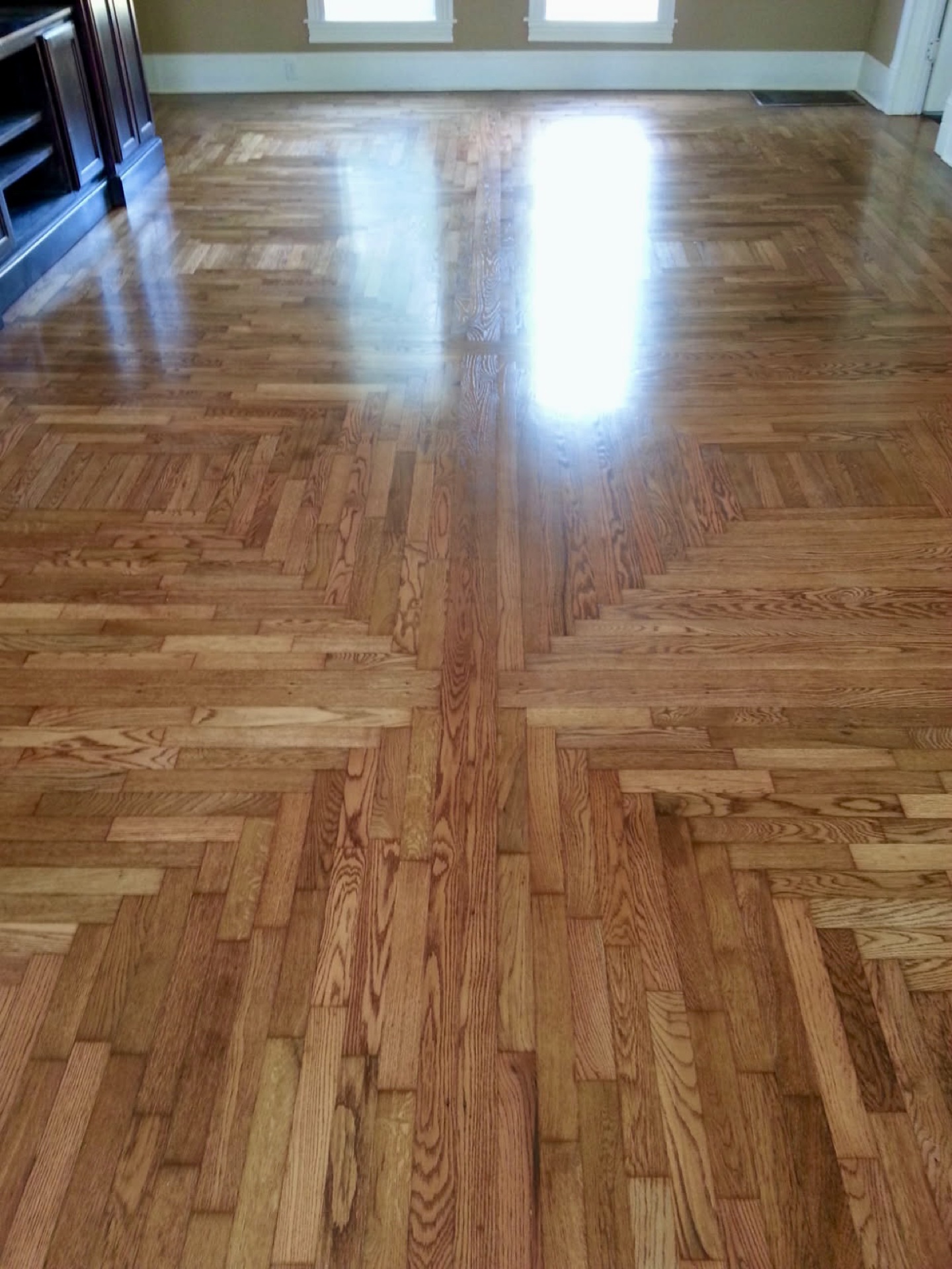 Refinished oak parquet hardwood floor with high-gloss Bona finish in a Fayetteville AR home