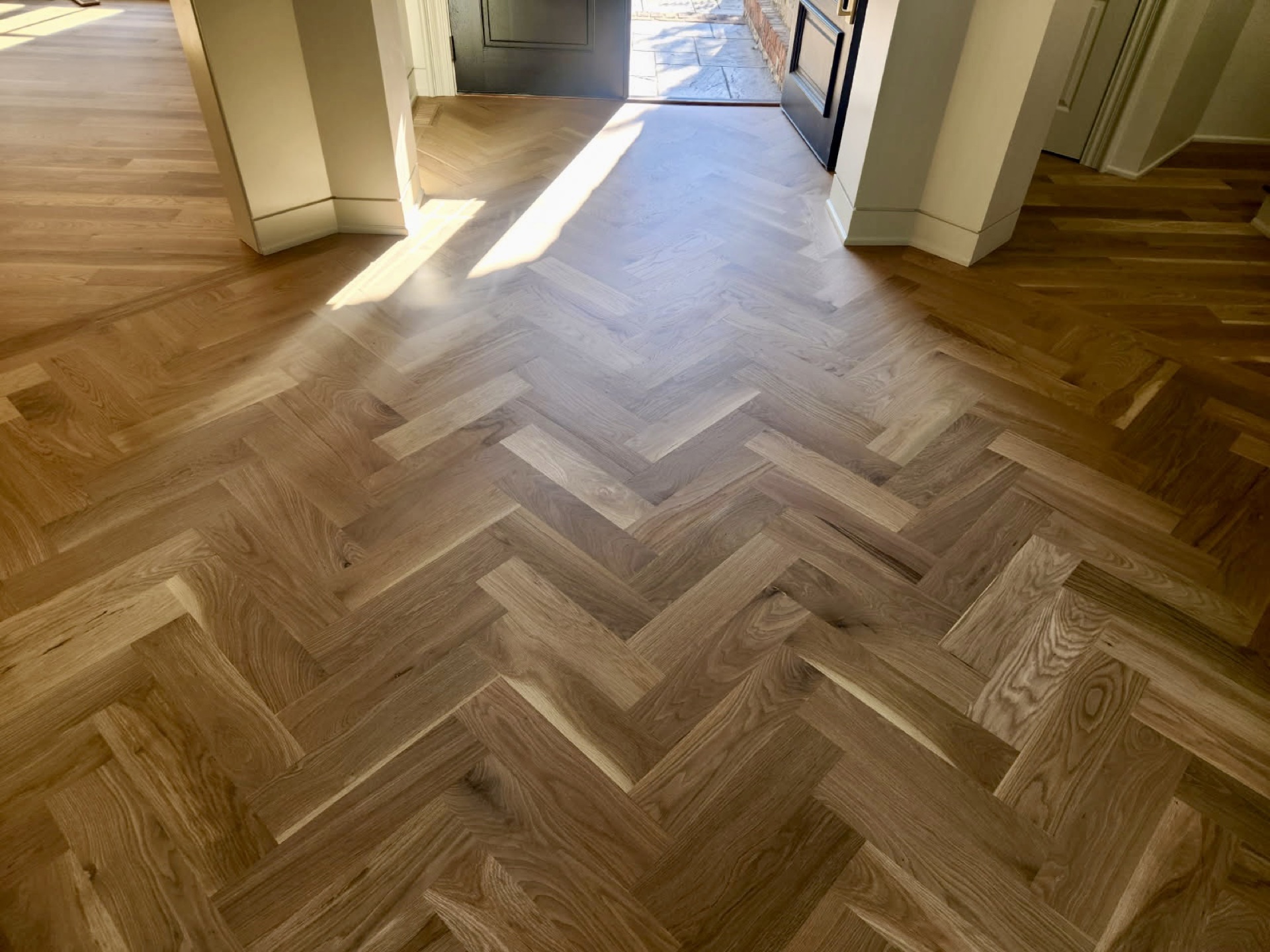 White oak herringbone hardwood floor entry installed in a Bentonville AR home